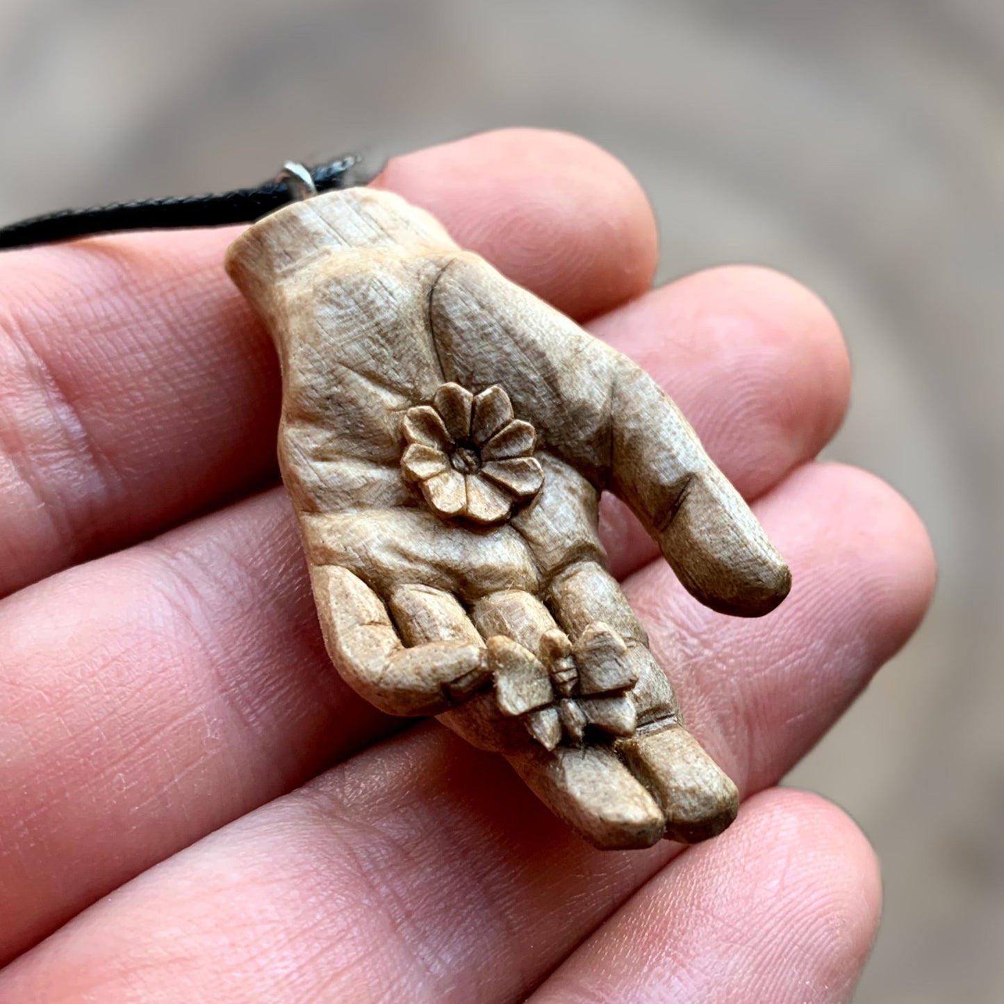 Hand With Butterfly and Flower Pendant