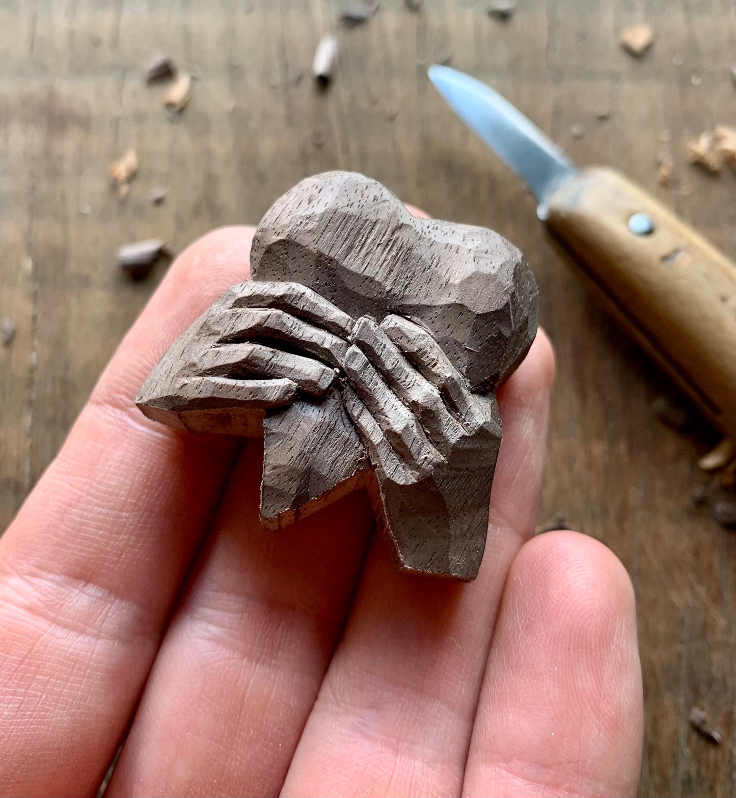 “Hands Squeezing Heart” Walnut Wood Pendant