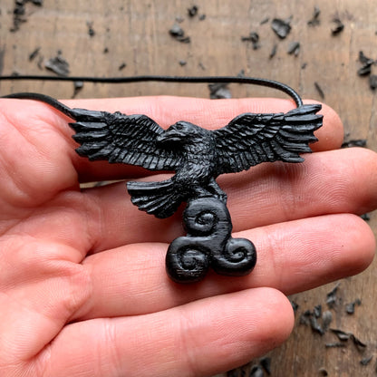 Flying Raven Holding Triskelion Pendant