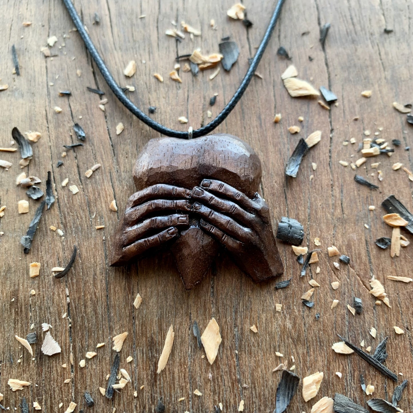 “Hands Squeezing Heart” Walnut Wood Pendant