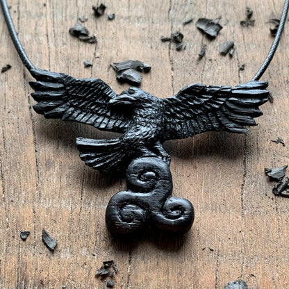 Flying Raven Holding Triskelion Pendant