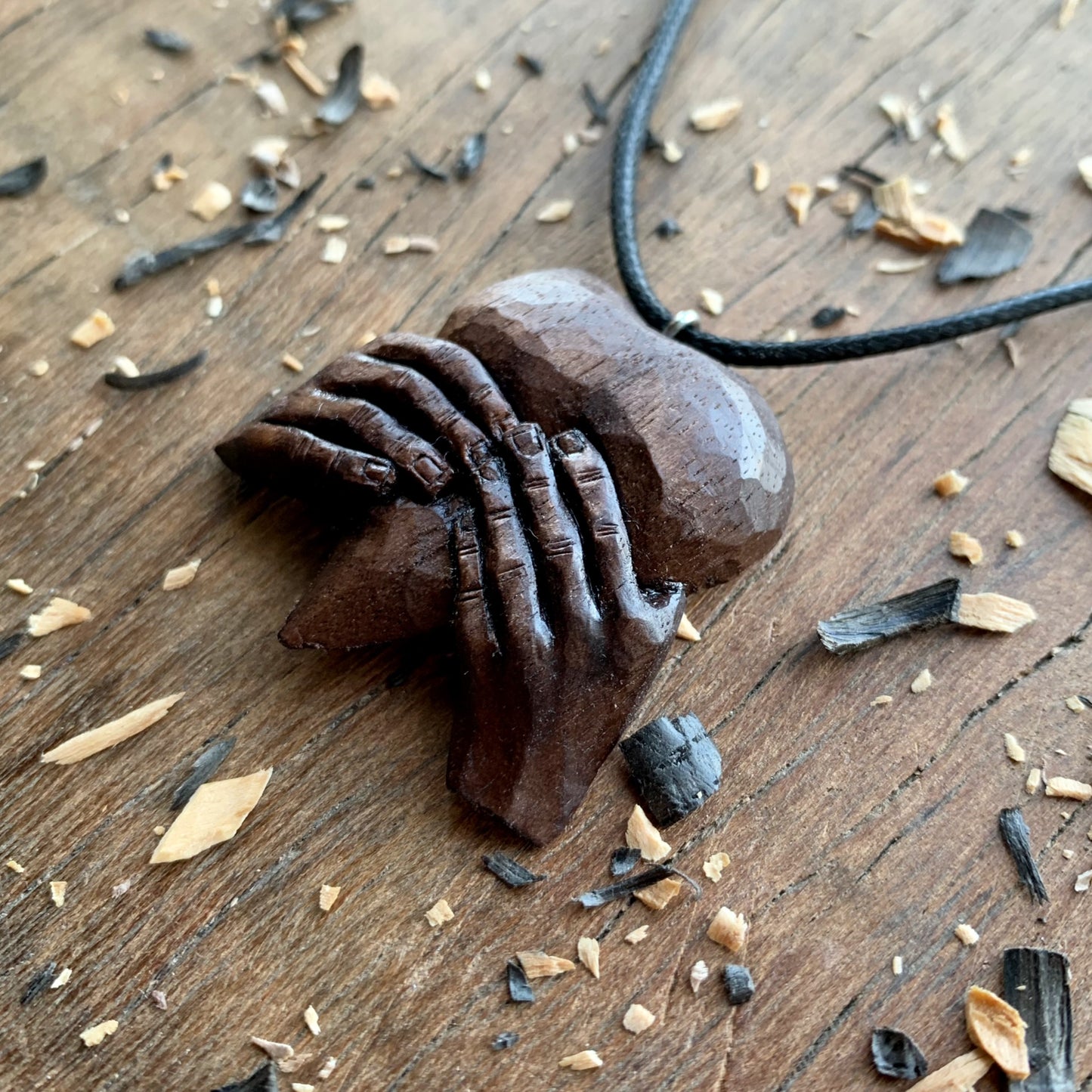 “Hands Squeezing Heart” Walnut Wood Pendant