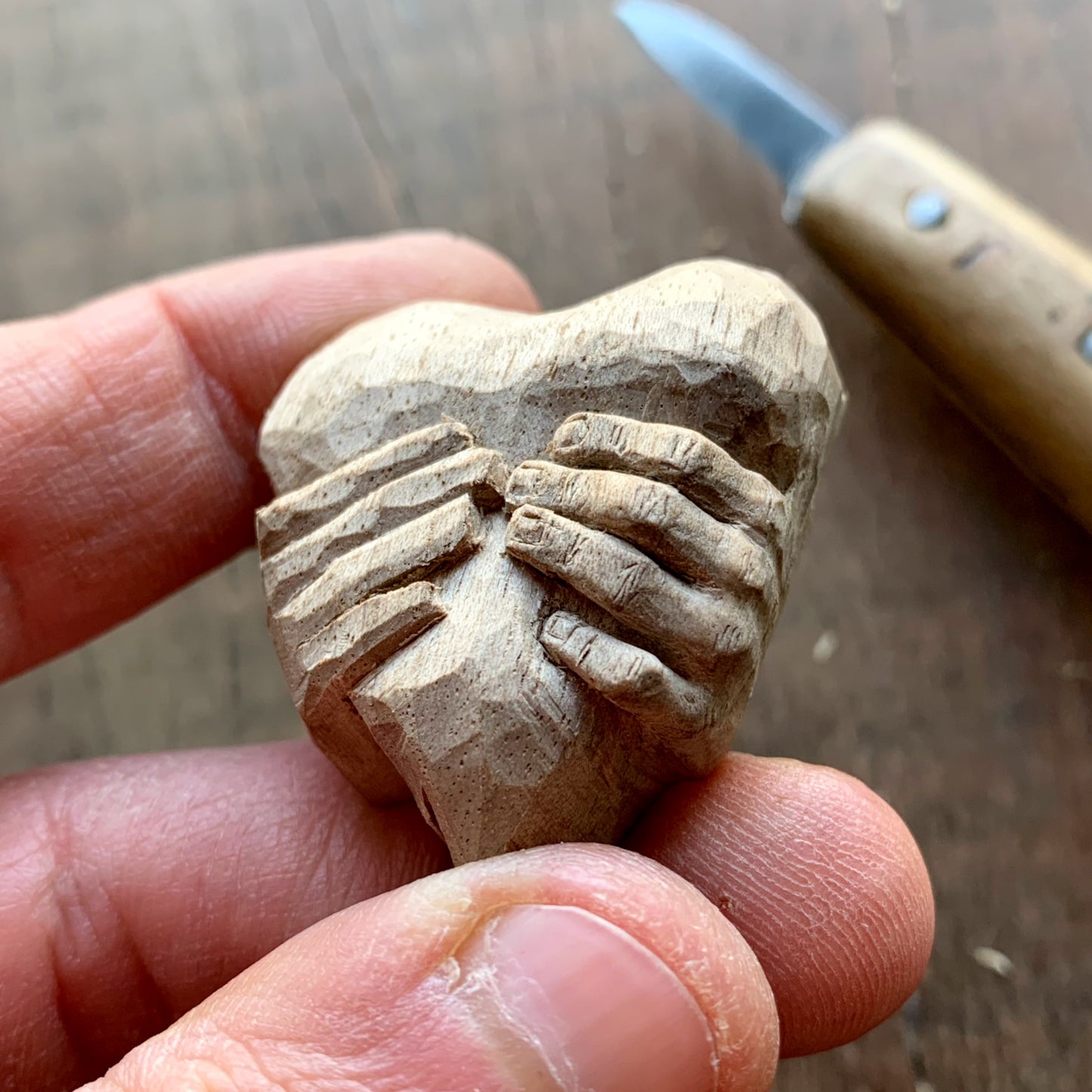 “Hands squeezing a Heart” Pendant