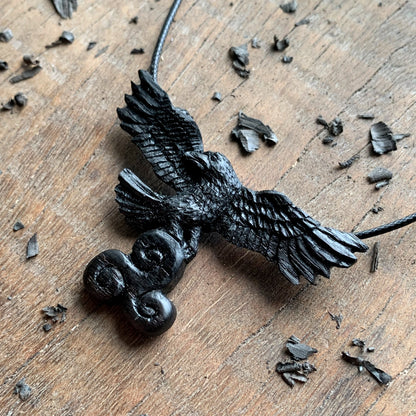 Flying Raven Holding Triskelion Pendant