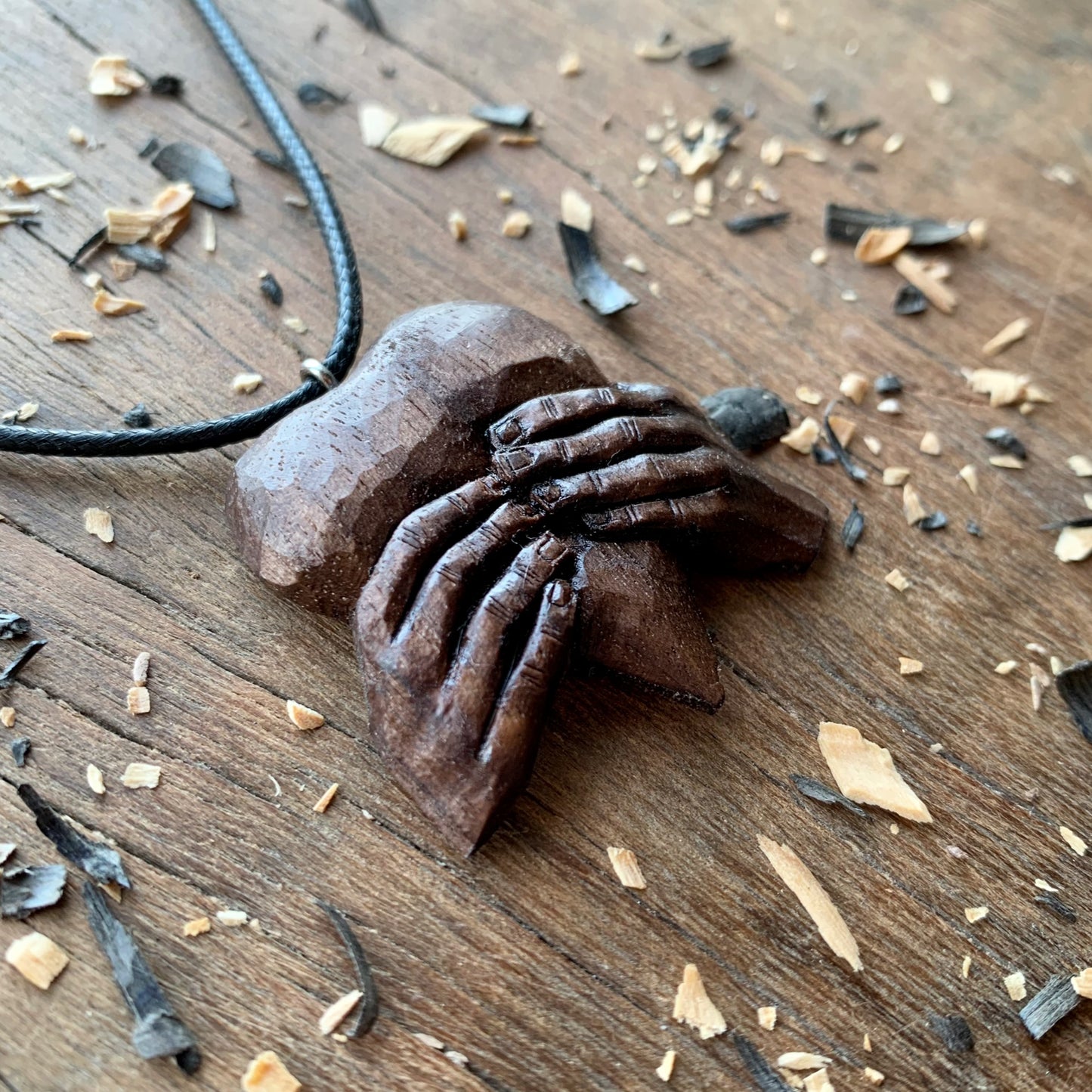 “Hands Squeezing Heart” Walnut Wood Pendant