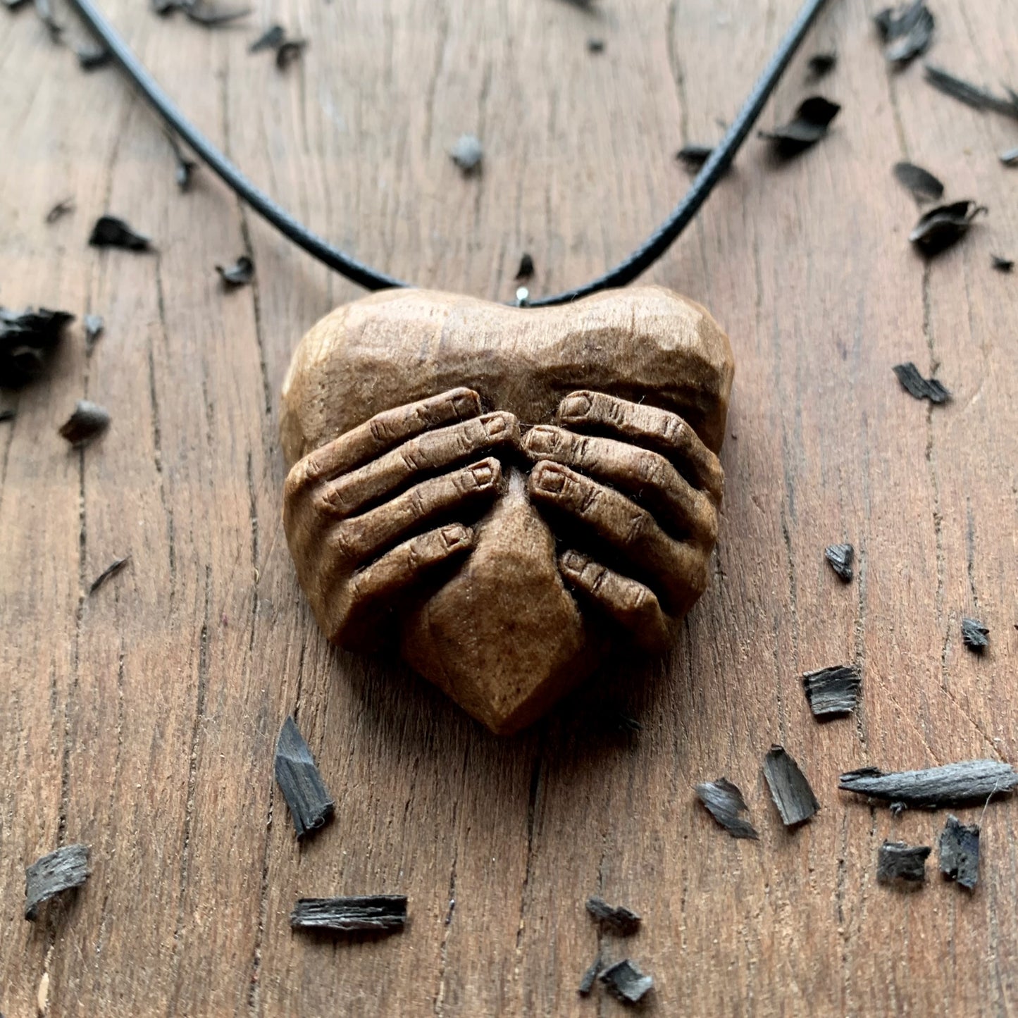 “Hands squeezing a Heart” Pendant