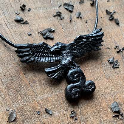 Flying Raven Holding Triskelion Pendant