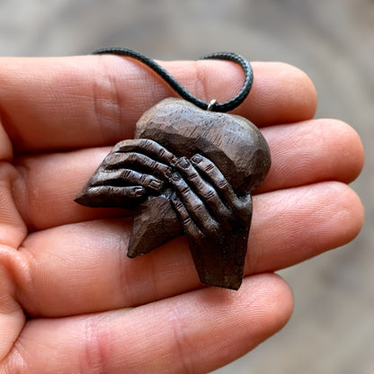 “Hands Squeezing Heart” Walnut Wood Pendant