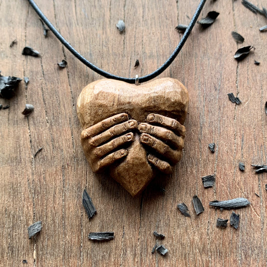 “Hands squeezing a Heart” Pendant
