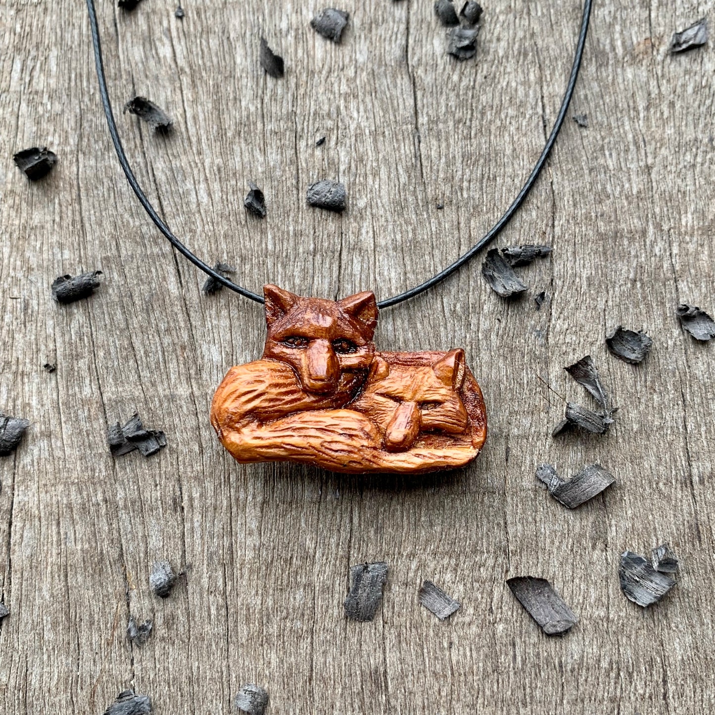 Two Lying Foxes Pendant, Plum Wood Necklace